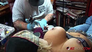 Shyla Stylez gets tattooed while playing with her tits